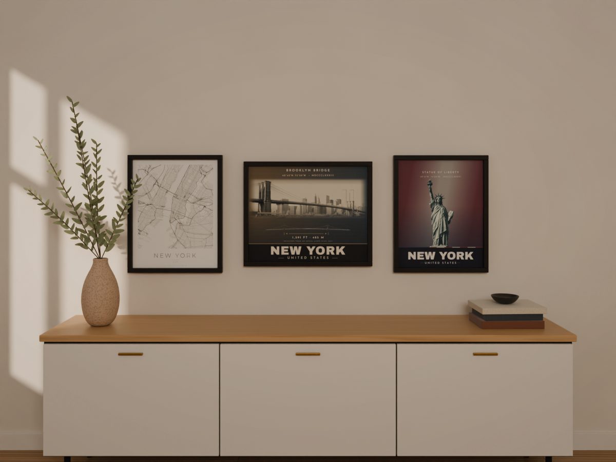 New York city map with the Brooklyn Bridge and Statue of Liberty posters, framed as a set above a sideboard